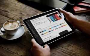 hands holding ipad showing WordPress dashboard